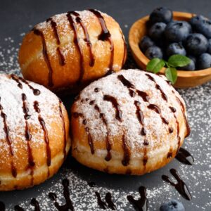 Donut or bun made from sweet yeast dough, poured with chocolate.