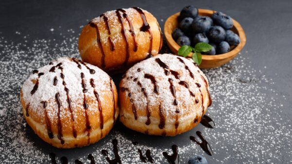 Donut or bun made from sweet yeast dough, poured with chocolate.